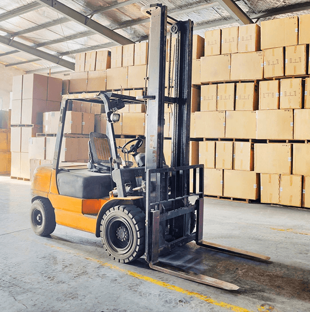 A forklift is parked in front of boxes.